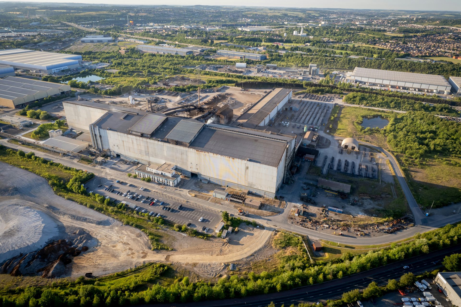 a large building with a road and trees around it